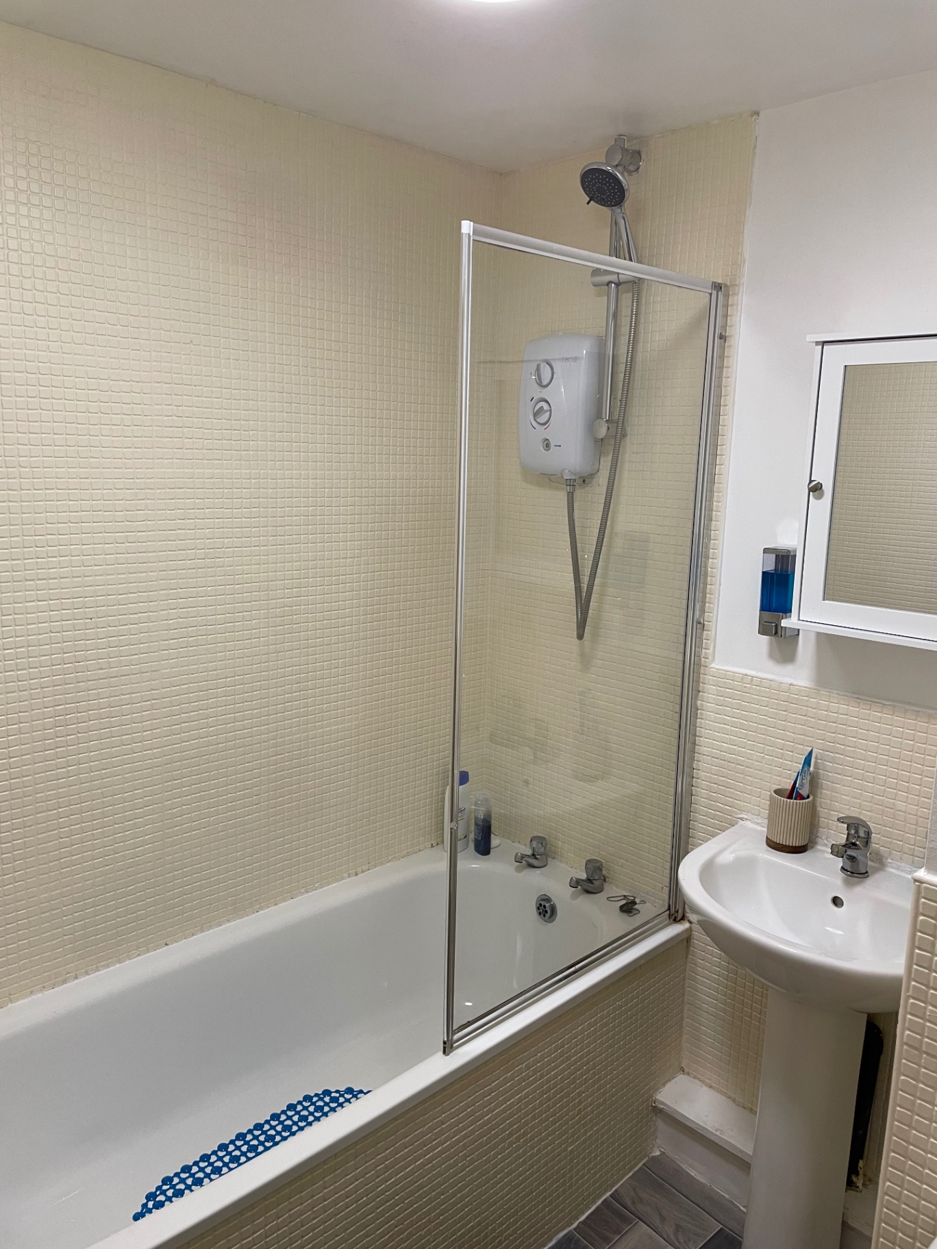 Bathroom after the clean with bath, shower screen and sink reset