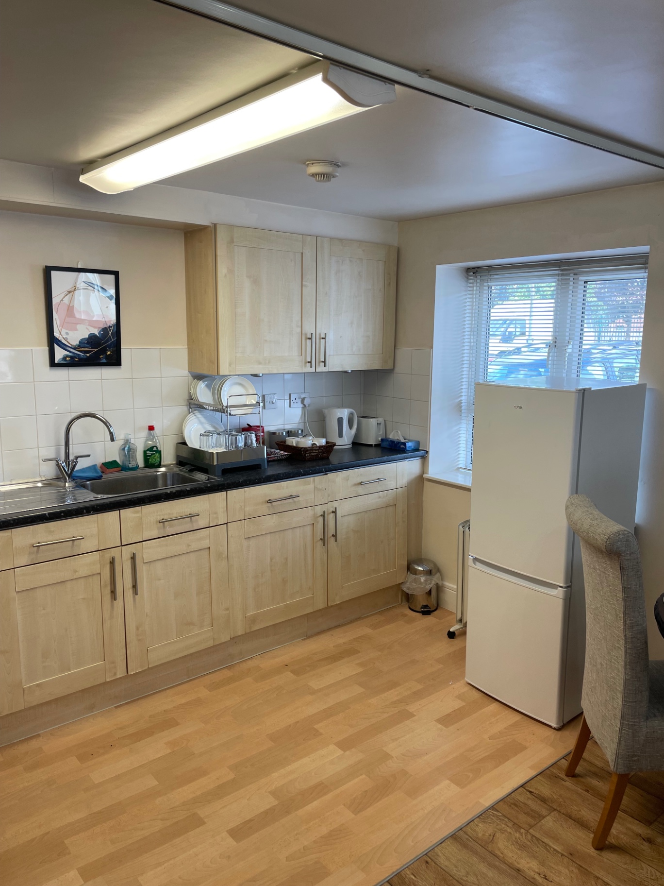 Kitchen before the turnover clean with dishes around the sink