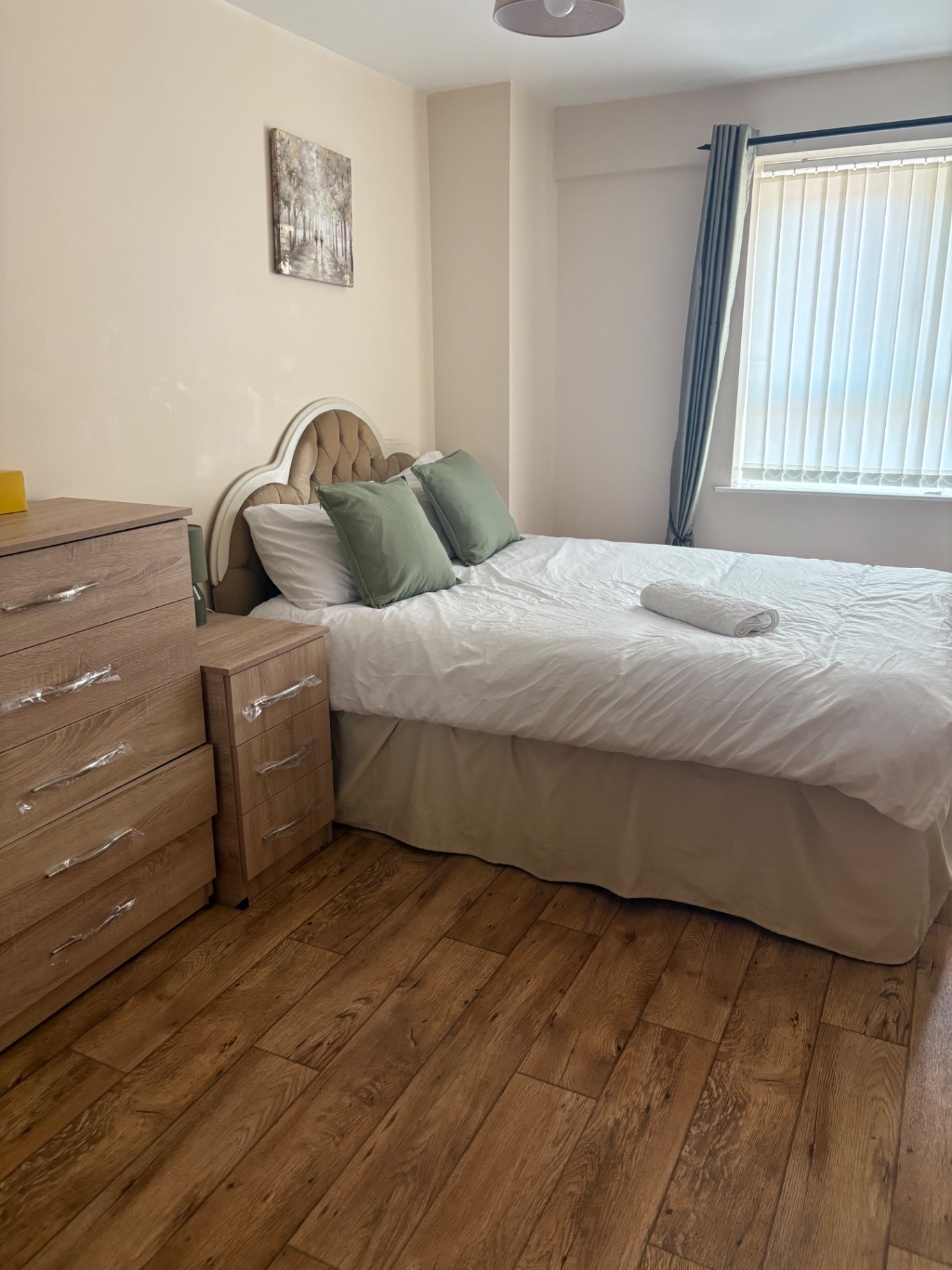 Bedroom staged with clean linen, cushions and folded towels